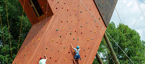 campers climbing tower
