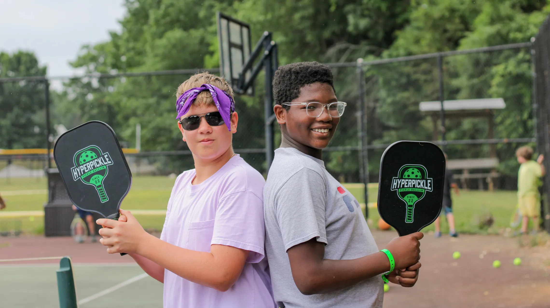 Two kids playing pickleball