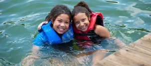 Girls swimming in lake